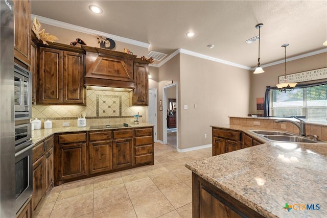3201 Purple Sage Dr, Belton, TX 76513 - kitchen featuring appliances with stainless steel finishes, tasteful backsplash, hanging light fixtures, a sink, and custom exhaust hood