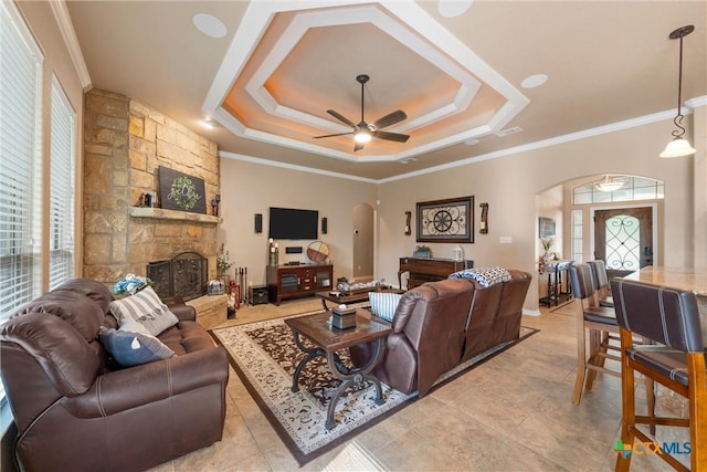 3201 Purple Sage Dr, Belton, TX 76513 - living area featuring a stone fireplace, arched walkways, ceiling fan, and ornamental molding