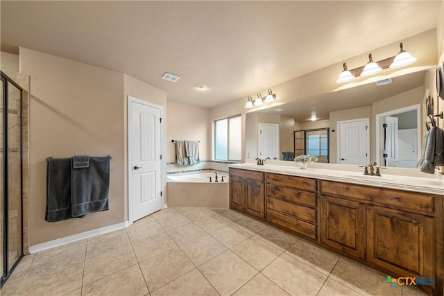 3201 Purple Sage Dr, Belton, TX 76513 - full bathroom featuring a garden tub, double vanity, visible vents, tile patterned floors, and a shower stall