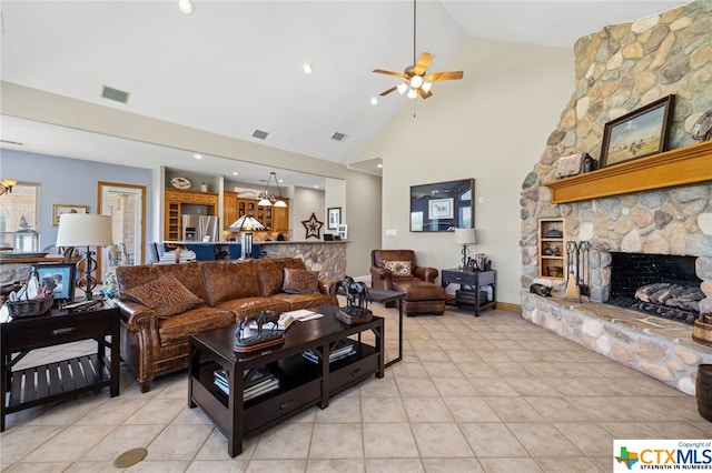 tiled living room featuring a fireplace, ceiling fan, and high vaulted ceiling