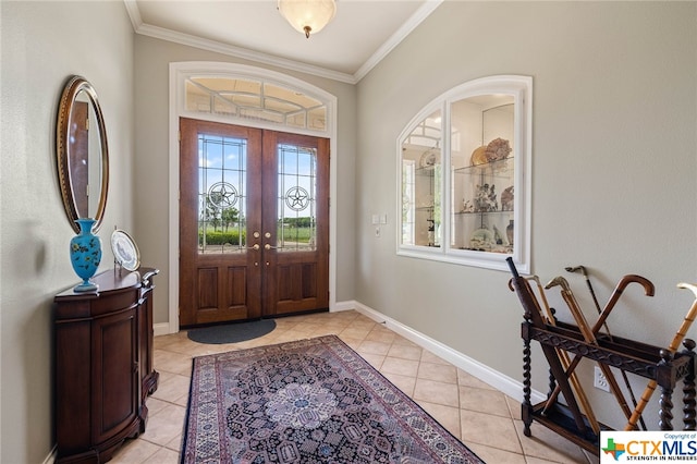 foyer with ornamental molding, french doors, and light tile patterned floors