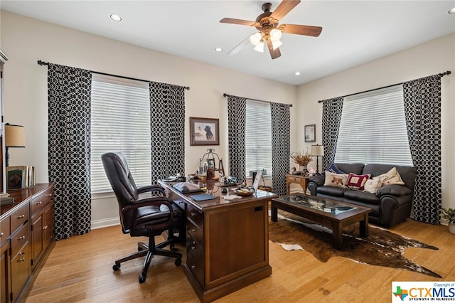 office with light hardwood / wood-style floors, ceiling fan, and plenty of natural light