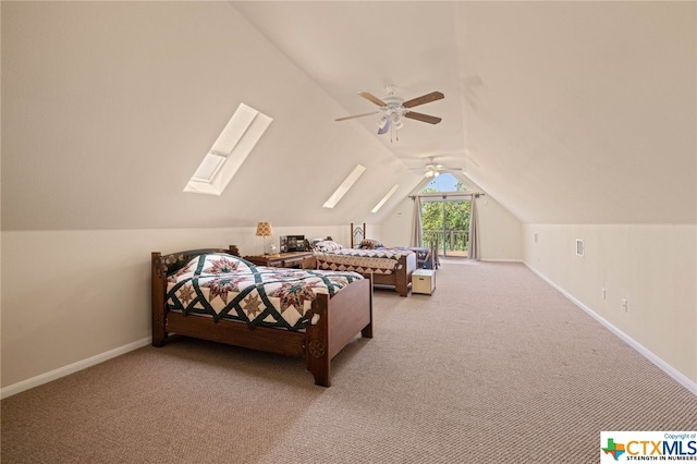 carpeted bedroom with ceiling fan and vaulted ceiling with skylight