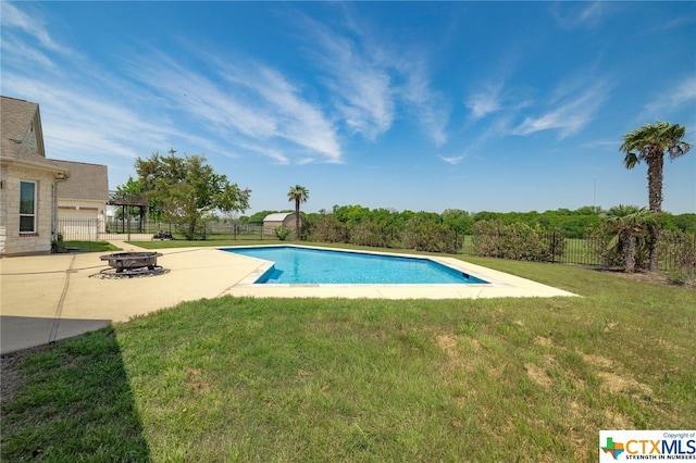 view of swimming pool featuring an outdoor fire pit, a lawn, and a patio area