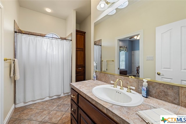 bathroom featuring vanity and shower / bathtub combination with curtain