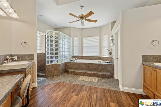 bathroom with independent shower and bath, vanity, wood-type flooring, and ceiling fan