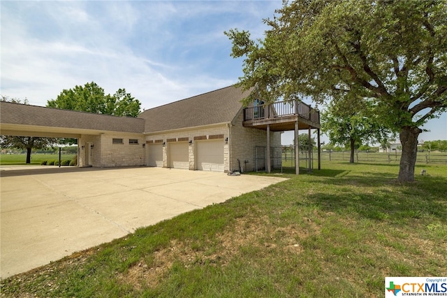 view of front of home featuring a garage, a front yard, and a carport