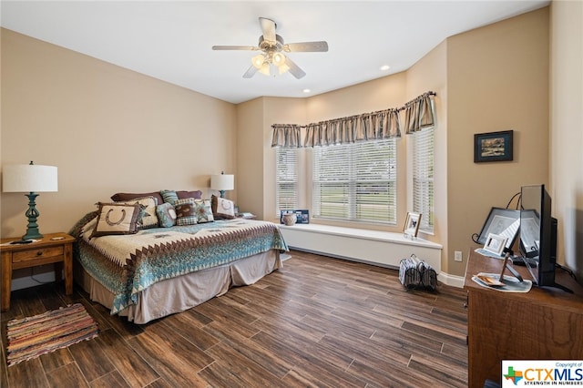 bedroom with ceiling fan and dark hardwood / wood-style floors