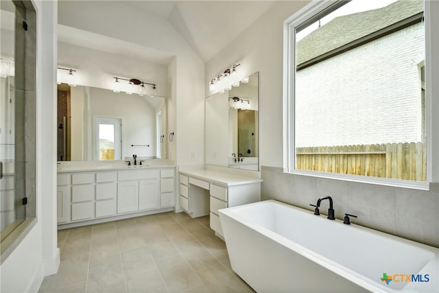 1923 Privet Rd, New Braunfels, TX 78132 - bathroom with plenty of natural light, a soaking tub, vanity, tile patterned flooring, and lofted ceiling