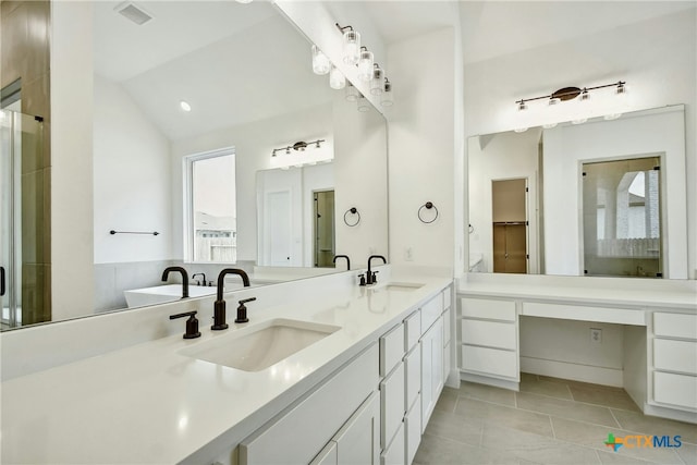 1923 Privet Rd, New Braunfels, TX 78132 - full bathroom featuring tile patterned floors, double vanity, vaulted ceiling, and a shower with door