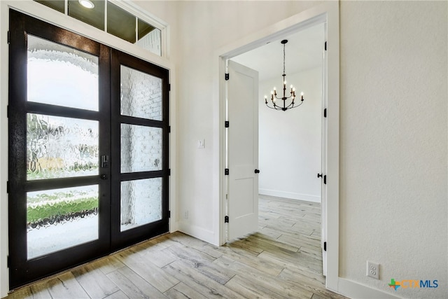 1923 Privet Rd, New Braunfels, TX 78132 - entrance foyer featuring a chandelier, french doors, wood finished floors, and plenty of natural light