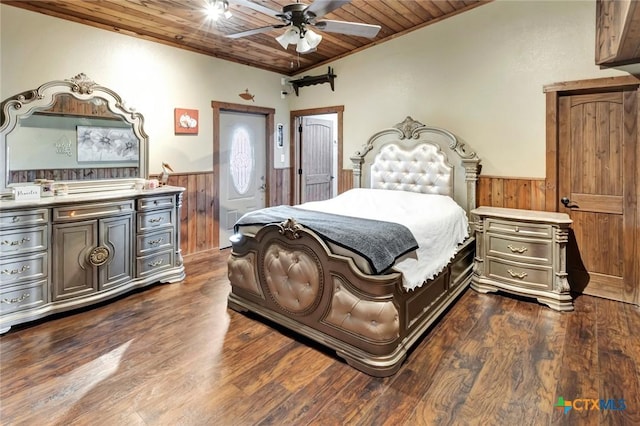 1622 Old Goliad Rd, Victoria, TX 77905 - bedroom with wainscoting, wood ceiling, wooden walls, dark wood finished floors, and ornamental molding