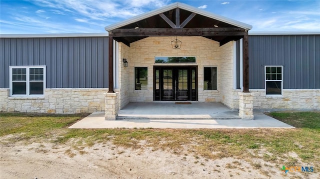 1622 Old Goliad Rd, Victoria, TX 77905 - doorway to property featuring stone siding, board and batten siding, and french doors