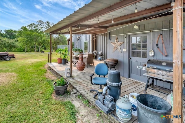 1622 Old Goliad Rd, Victoria, TX 77905 - wooden deck featuring a yard, outdoor dining area, and a grill