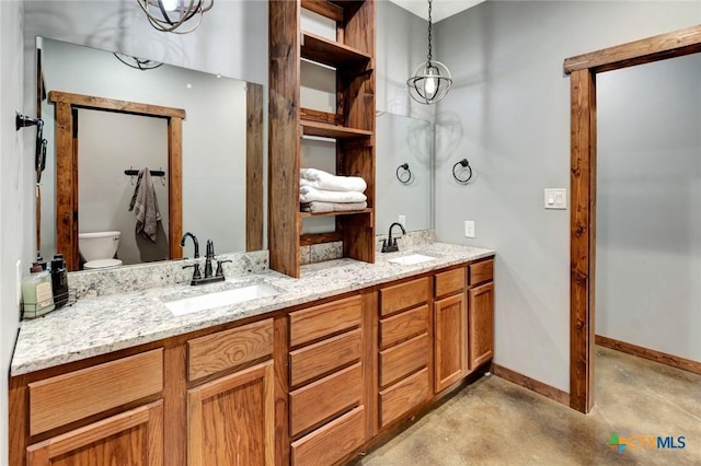 1622 Old Goliad Rd, Victoria, TX 77905 - bathroom featuring toilet, double vanity, concrete flooring, and baseboards
