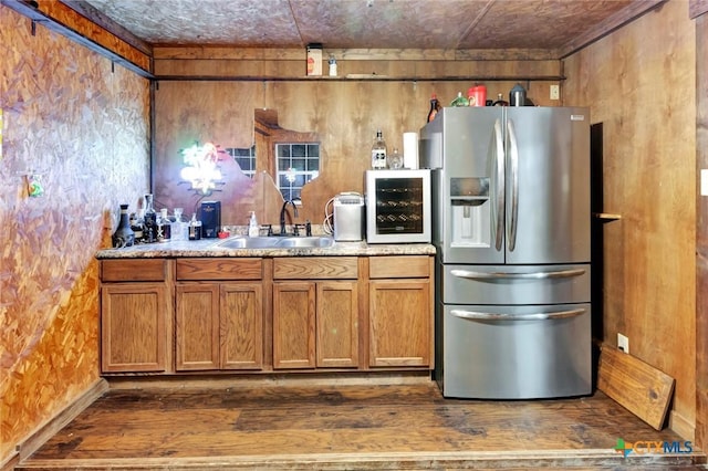1622 Old Goliad Rd, Victoria, TX 77905 - kitchen with stainless steel refrigerator with ice dispenser, a sink, brown cabinets, and light countertops