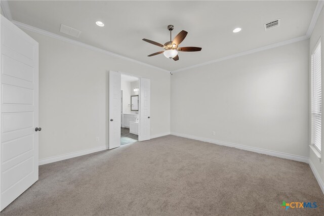 carpeted spare room with ceiling fan and ornamental molding