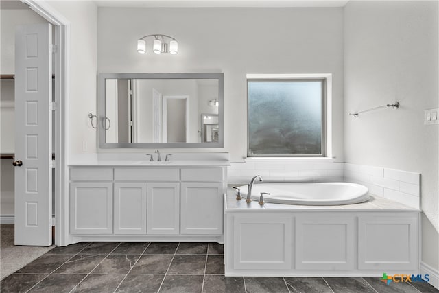 bathroom with a bathing tub, tile patterned flooring, and vanity