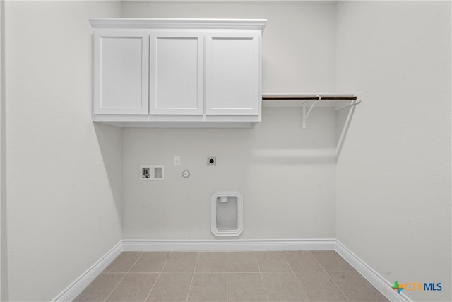 washroom with cabinets, hookup for an electric dryer, light tile patterned floors, hookup for a washing machine, and hookup for a gas dryer