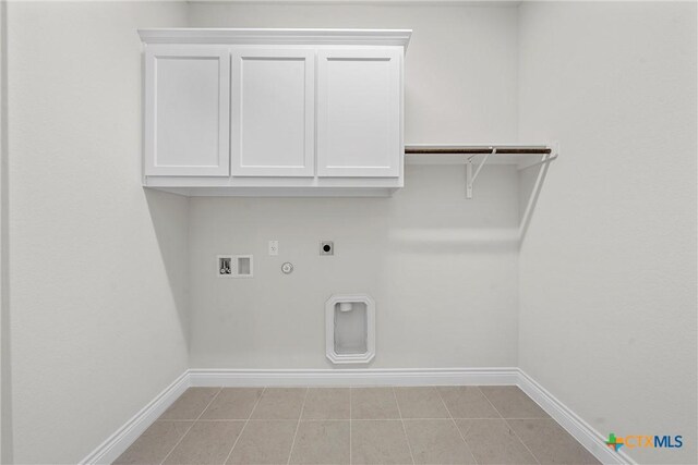 6402 Waggoner Ct, Temple, TX 76502 - washroom with cabinets, hookup for an electric dryer, light tile patterned floors, hookup for a washing machine, and hookup for a gas dryer
