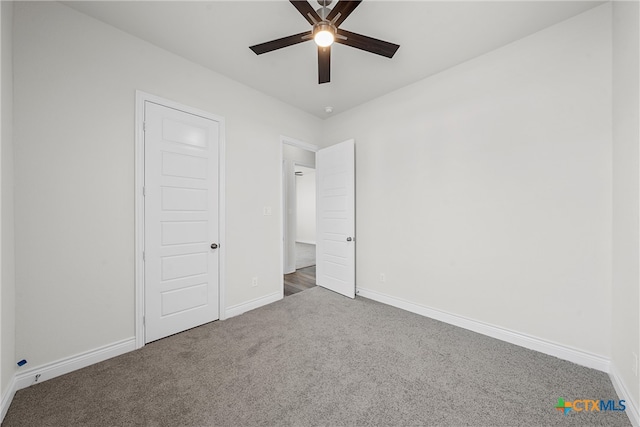 unfurnished bedroom with ceiling fan and carpet