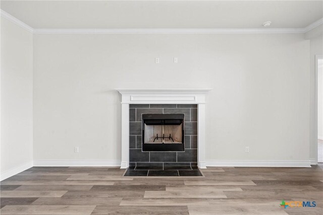 6402 Waggoner Ct, Temple, TX 76502 - room details featuring a fireplace, hardwood / wood-style flooring, and crown molding