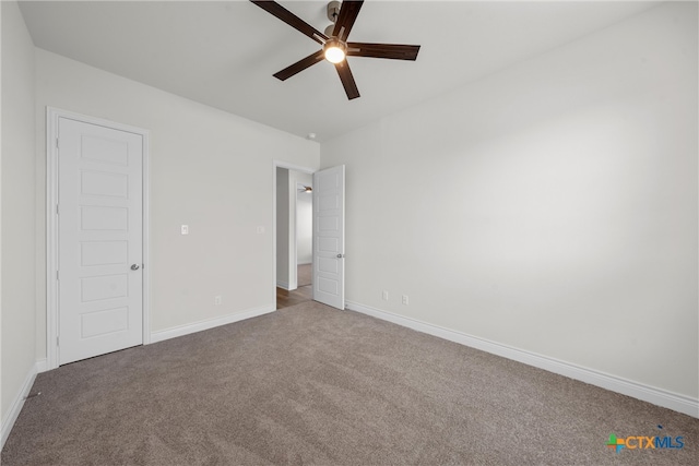 carpeted empty room featuring ceiling fan