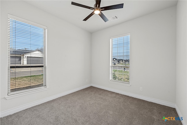 spare room with carpet and ceiling fan