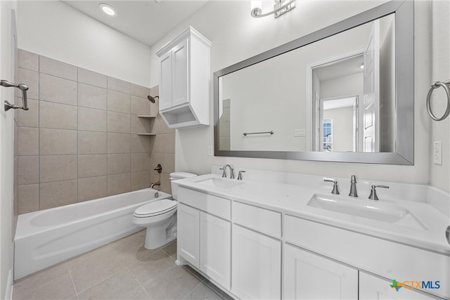 full bathroom with toilet, tiled shower / bath combo, vanity, and tile patterned flooring