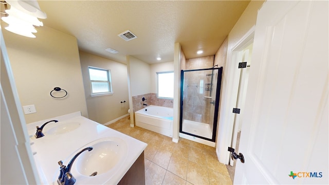 bathroom featuring vanity, a textured ceiling, tile patterned flooring, and separate shower and tub