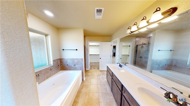 bathroom featuring vanity, tile patterned floors, and plus walk in shower