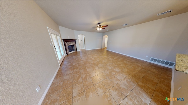 unfurnished living room featuring ceiling fan