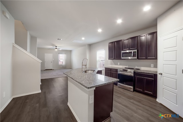 7147 Azure Waters, Converse, TX 78109 - kitchen featuring appliances with stainless steel finishes, dark wood-type flooring, a kitchen island with sink, open floor plan, and recessed lighting
