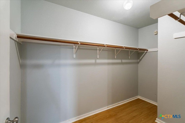2102 Garrison Dr, Leander, TX 78641 - walk in closet with wood finished floors