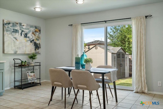 2102 Garrison Dr, Leander, TX 78641 - dining area with light tile patterned floors and baseboards