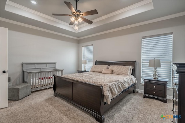 bedroom with light carpet and a raised ceiling