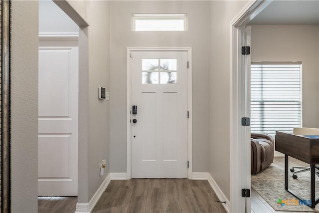 entryway featuring wood finished floors and baseboards