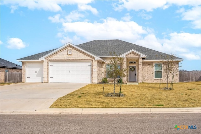 view of front facade with a garage, driveway, a front lawn, and fence