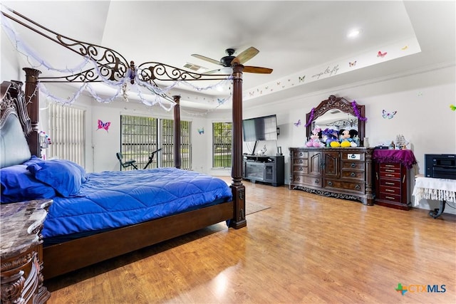 2106 Antelope Trl, Harker Heights, TX 76548 - bedroom with wood finished floors, a tray ceiling, recessed lighting, access to exterior, and a ceiling fan