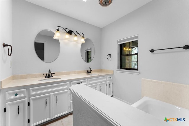 2106 Antelope Trl, Harker Heights, TX 76548 - bathroom featuring double vanity, a bath, and tile patterned floors