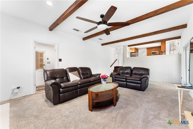 2106 Antelope Trl, Harker Heights, TX 76548 - carpeted living area featuring a ceiling fan, beamed ceiling, stairway, and brick wall