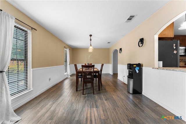 2106 Antelope Trl, Harker Heights, TX 76548 - dining space featuring arched walkways, dark wood-style floors, and wainscoting