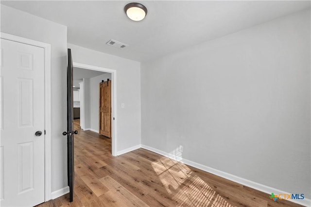 unfurnished room with visible vents, baseboards, and light wood-style flooring