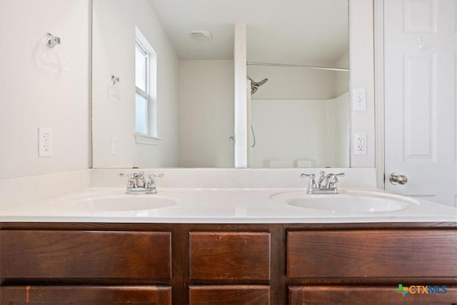 full bath with double vanity and a sink
