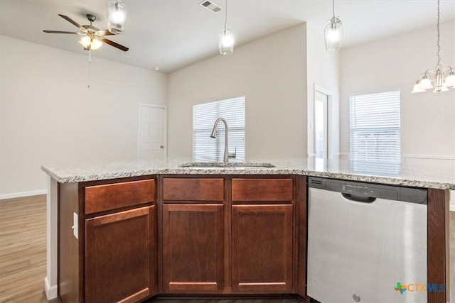 kitchen featuring ceiling fan with notable chandelier, a sink, visible vents, dishwasher, and light stone countertops