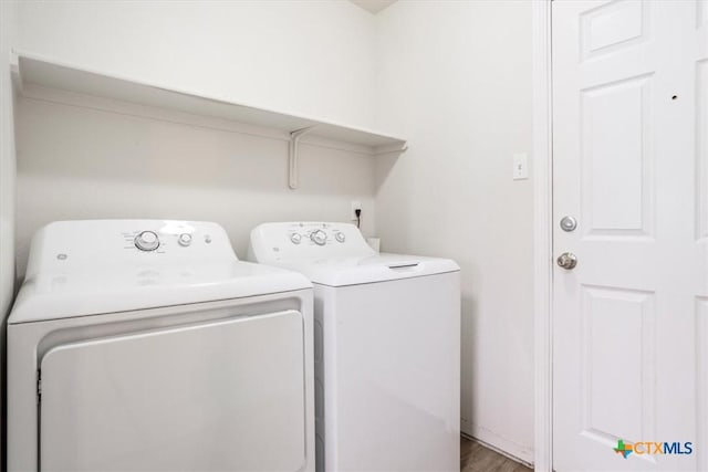 clothes washing area featuring washer and dryer, laundry area, and light wood-type flooring