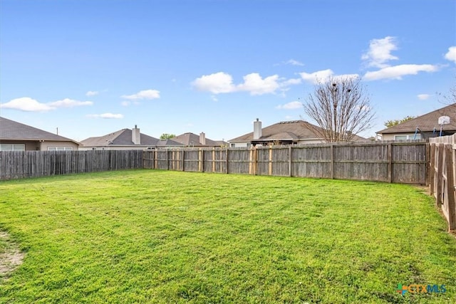 view of yard with a fenced backyard