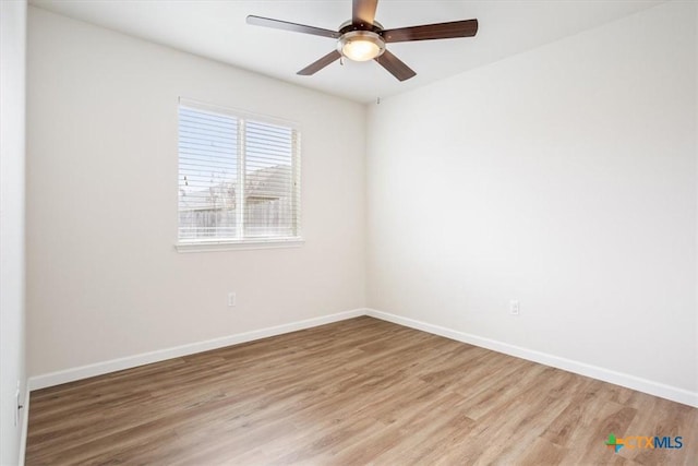 unfurnished room featuring baseboards, a ceiling fan, and light wood finished floors