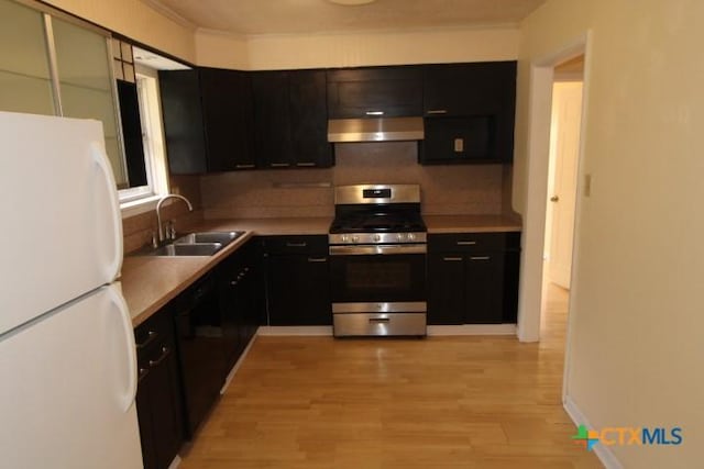 1007 E Robertson Ave, Copperas Cove, TX 76522 - kitchen featuring freestanding refrigerator, gas range, under cabinet range hood, a sink, and dishwasher