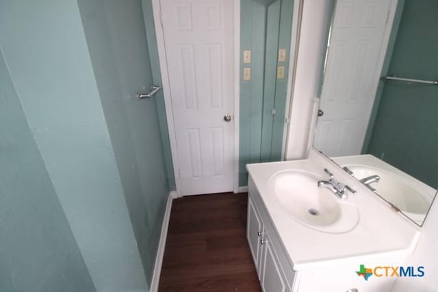 1007 E Robertson Ave, Copperas Cove, TX 76522 - bathroom featuring wood finished floors, vanity, and baseboards